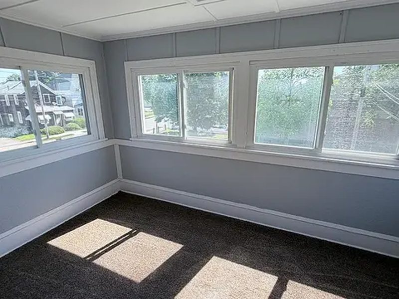 Sunroom with wraparound windows